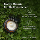 Whipped Squalane Face & Eye Cream in a recyclable jar surrounded by green clover, highlighting its vegan and preservative-free qualities.