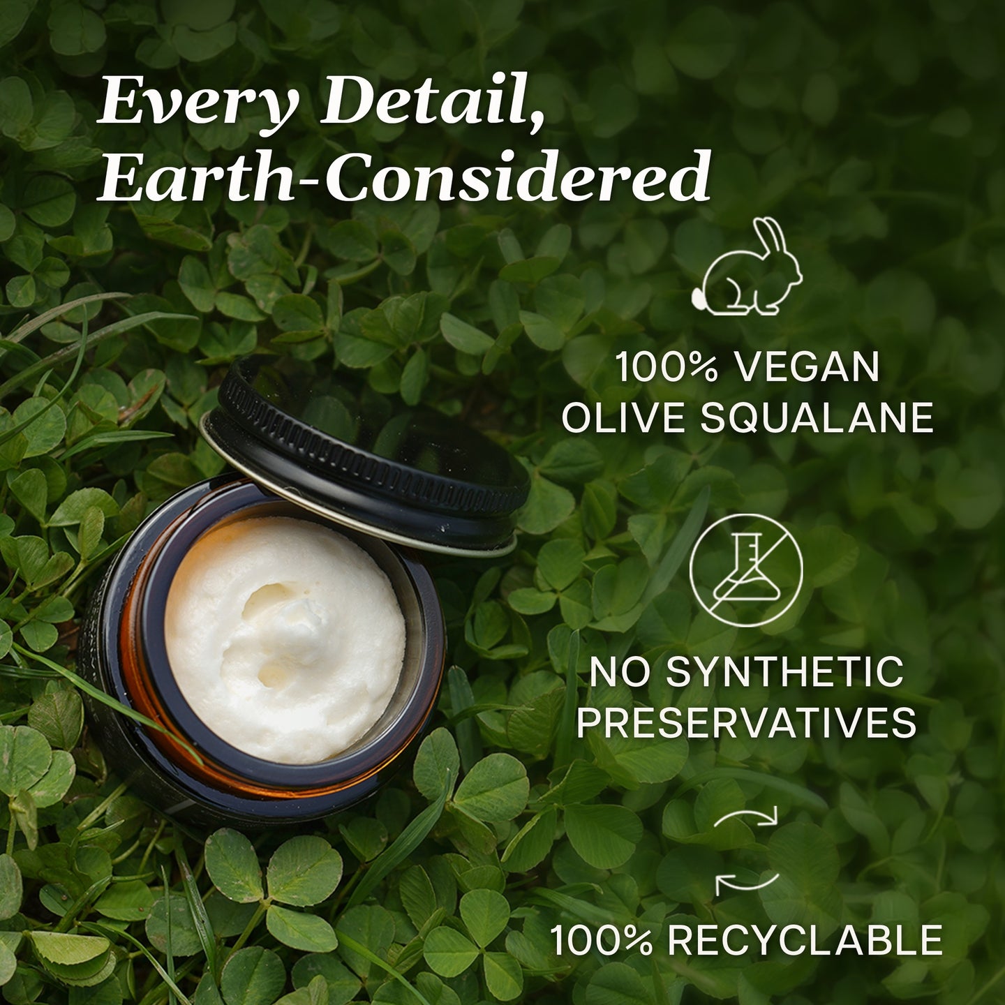 Whipped Squalane Face & Eye Cream in a recyclable jar surrounded by green clover, highlighting its vegan and preservative-free qualities.